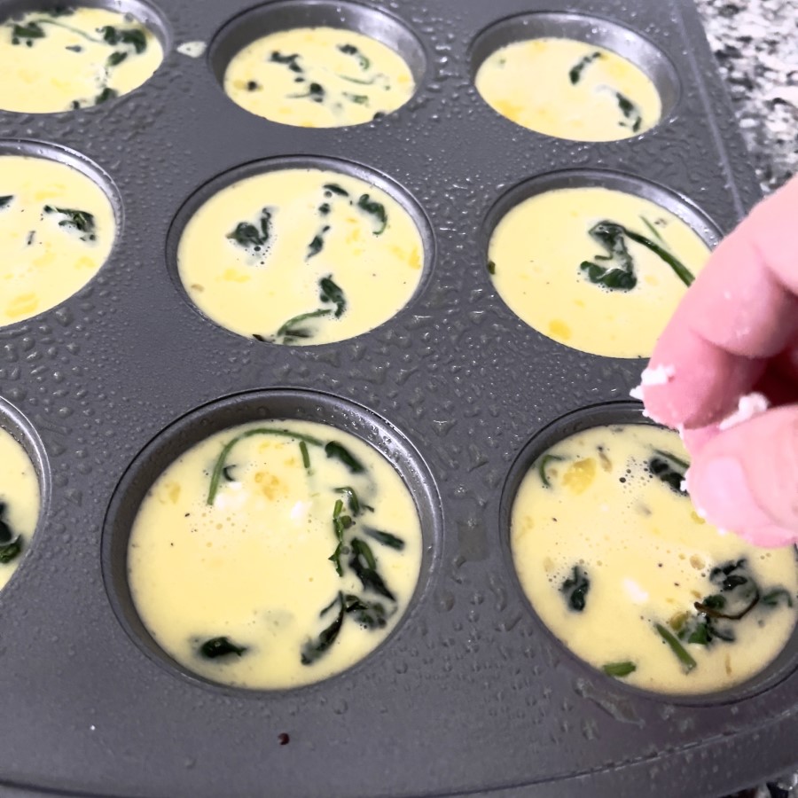 Sprinkle feta cheese on each egg bite cup.