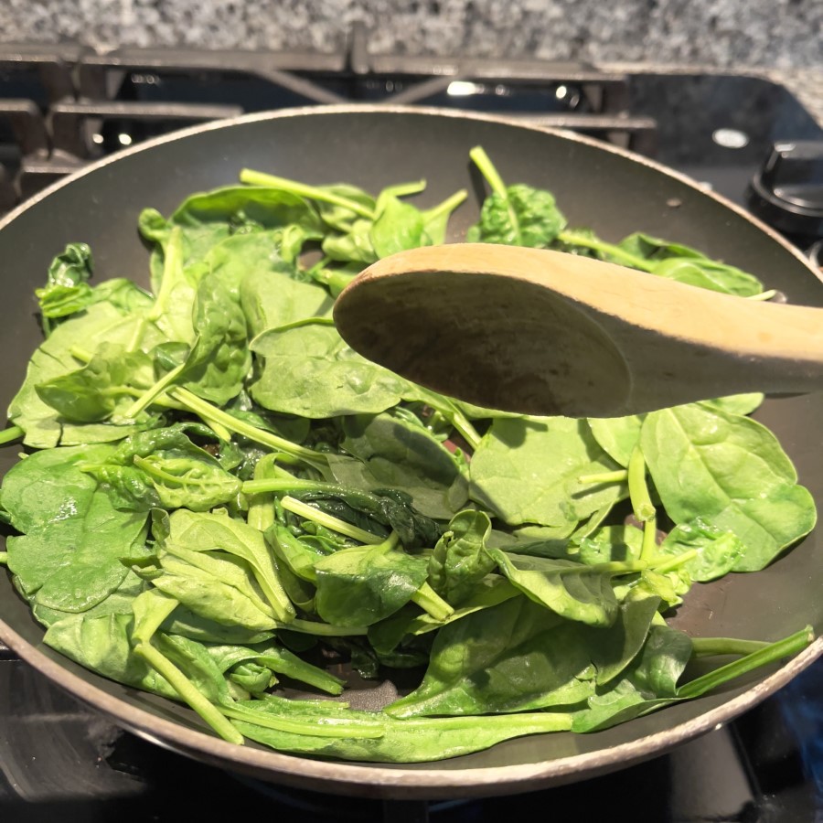 Saute organic raw spinach to wilt it for Spinach and Feta Egg Bites.