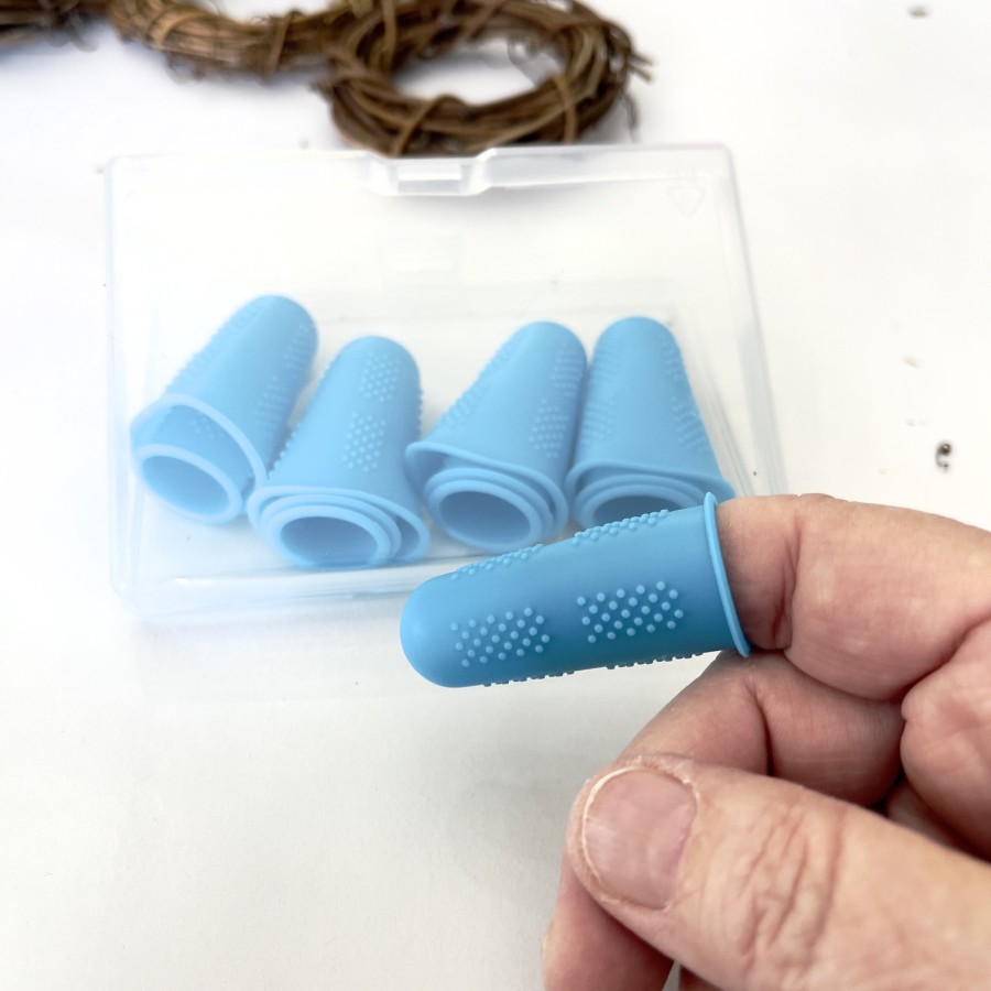 Blue silicone finger protection from hot glue.