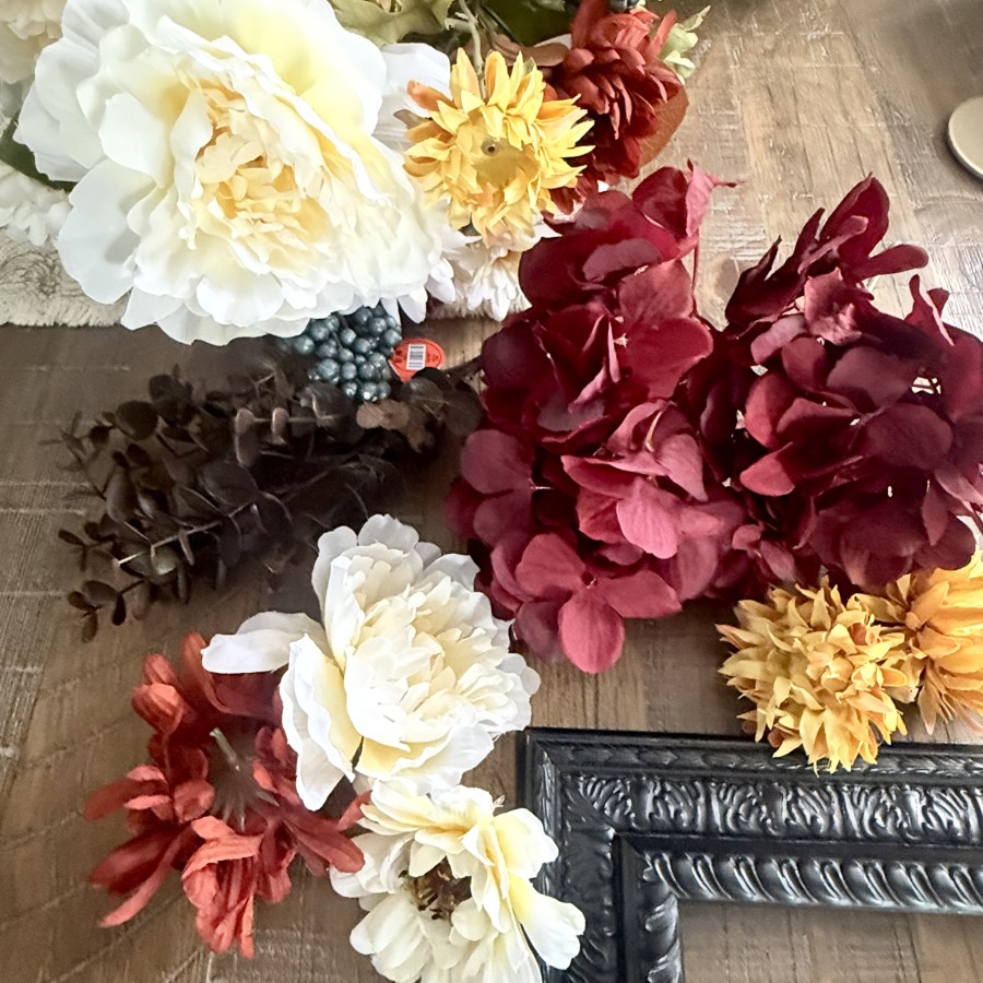 Assortment of fall faux flowers in hues of burgundy, rust, golds and creams.